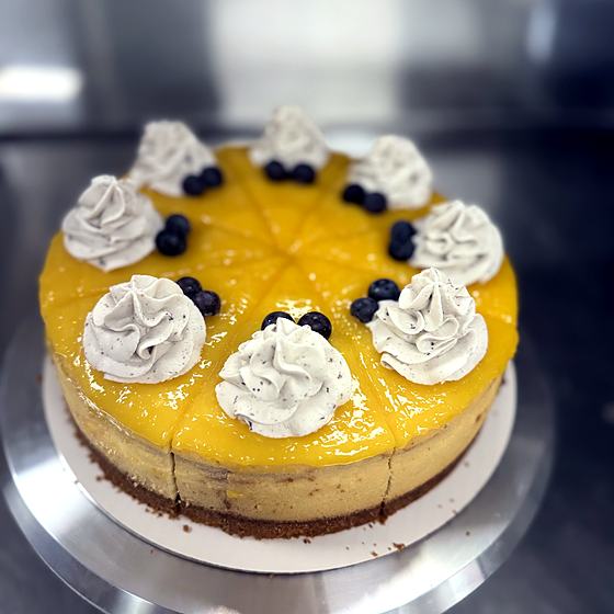 A mango and blueberry topped cheesecake made by Something Sweet Pasteleria.